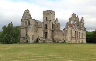 Stone ruins of a medieval monastery on green grass in rural Estonia