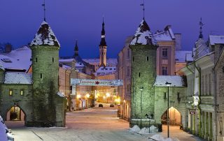 Twilight view of Viru Gate towers in Tallinn, Estonia, illuminated at night