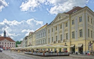 Historic pastel buildings lining Tallinn’s Old Town cobblestone street