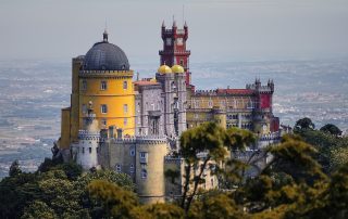 Colorful Pena Palace on hilltop in Sintra, Portugal – whimsical architecture and lush views