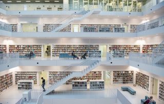 Modern multi-level library interior with clean lines – open-concept design with staircases and bright lighting