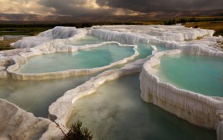 Natural travertine pools at Pamukkale with mineral-rich water formations
