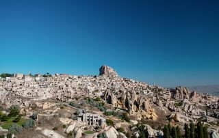 Rocky hills and clustered homes in Cappadocia, Turkey – panoramic daylight vie