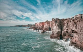 Dramatic ocean cliffs with turquoise waters – rugged coastline ideal for cinematic views