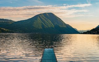 Dockside view over Lake Como, Italy – peaceful waterfront framed by mountain backdrop