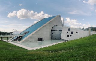 Modern white building in green landscape under blue sky in Turkey