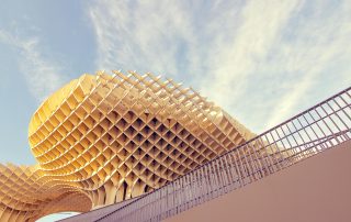 Golden honeycomb-like facade of Metropol Parasol in Seville – dramatic lattice architecture at sunset