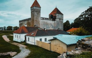 Medieval castle complex with towers in Tartu, Estonia under clear skies