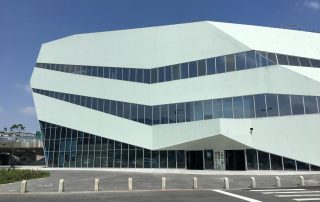 Contemporary glass and steel building with geometric design – sleek urban structure under daylight