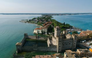 Medieval coastal fortress in Italy – cinematic blend of stone ramparts and turquoise waters.