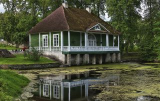 Wooden summer cottage nestled in forest by a peaceful lake in Estonia