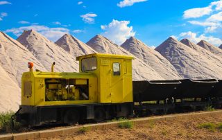 Bright yellow train crossing through desert mountains of Turkey
