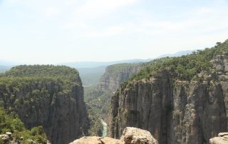 Vast canyon cliffs and rugged green terrain in Turkish countryside