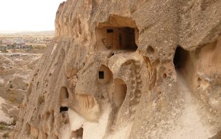 Ancient cave dwellings carved into Uchisar rock formations in Cappadocia, Turkey